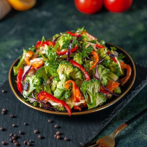 front-view-vegan-salad-with-fresh-ingredients-plate-pepper-black-cutting-board