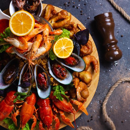 seafood plate with shrimps, mussels, lobsters served with lemon